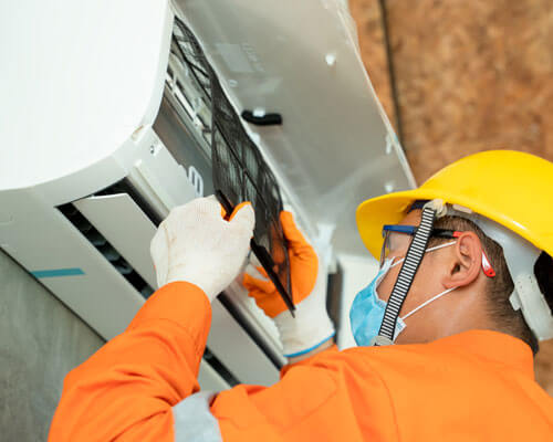 Technician Man In Medical Mask Installing Air Conditioners,techn