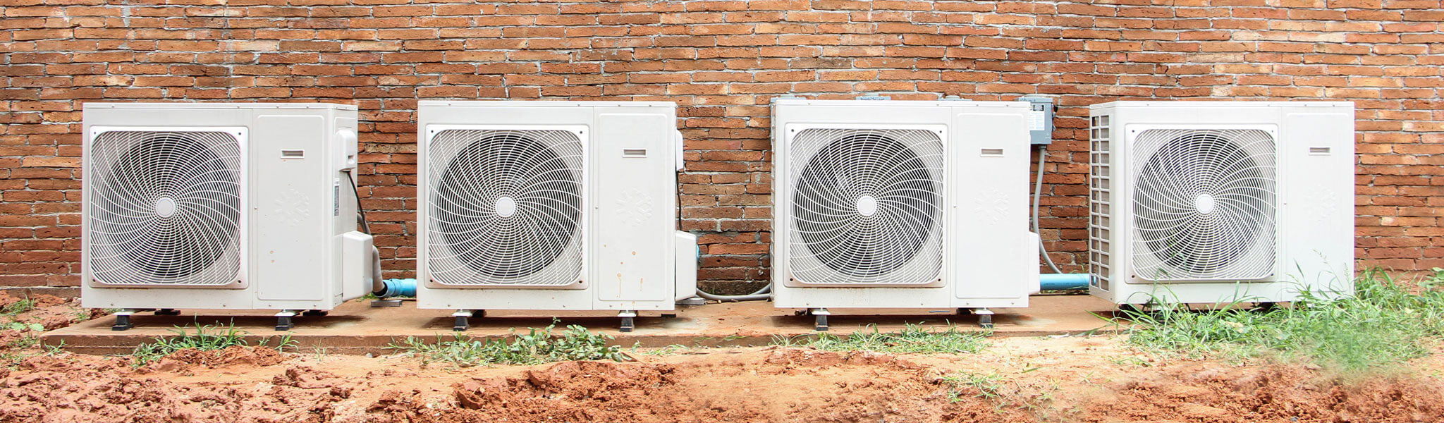 Air Conditioning Compressor On Brick Wall.