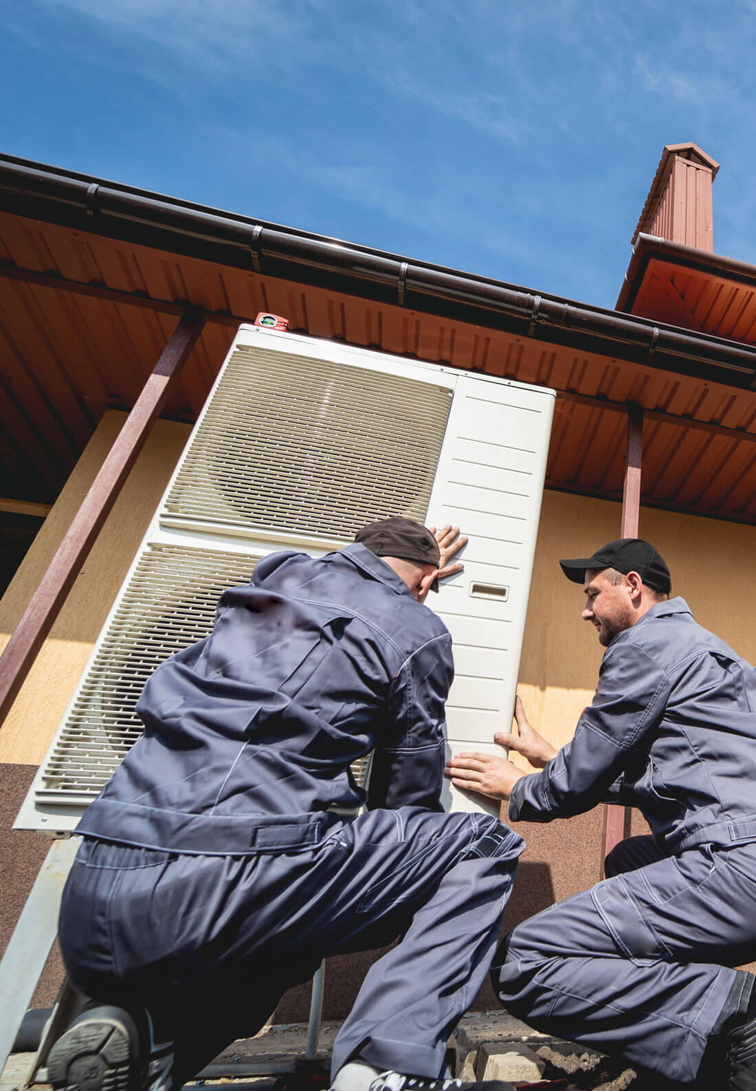Hvac Technicians Servicing Home Heating And Cooling System Hvac Technicians Servicing Home Heating And Cooling System