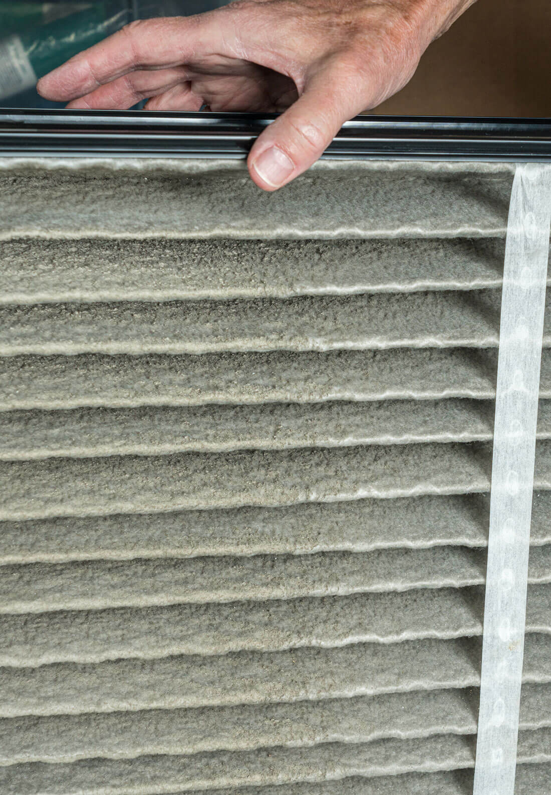 Senior Man Changing A Dirty Air Filter In A Hvac Furnace