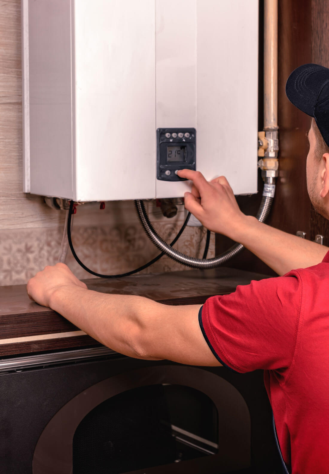 Plumber Adjusts Gas Boiler Before Operating